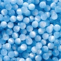 Macro detail of sky blue resin cat eye beads for DIY handmade jewelry crafting - Blue