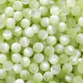 Macro shot of light green resin beads with cat eye effect for DIY jewelry making - Light Green