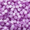 Macro detail of light purple resin cat-eye beads with smooth finish for DIY jewelry making - Purple