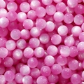 Detailed view of pink resin cat eye beads with chatoyancy effect for DIY jewelry making - 8mm (20 Pcs/Pack, 1.6mm Hole) / Rose Red
