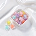Macro shot of colorful acrylic flower beads in a white bowl for DIY jewelry making - Transparent Cross Core Bead