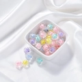 Macro detail of mixed macaron acrylic beads with ribbed texture on silk fabric - Transparent Melon Core Bead
