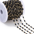 Detail of DIY jewelry chain with black rectangular beads and gold spacers on a spool - Rectangular Stone Bead Style / 1 Meter / Black (Gold Chain)