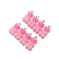Close-up of pink gradient resin bear charms with glitter and silver metal hanging loops - Opaque Rose Pink