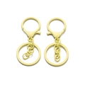 Dettaglio di due portachiavi giallo chiaro opaco con moschettoni e anelli metallici - Giallo chiaro