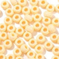 Macro detail of cream-colored acrylic beads with smooth finish and large center holes - 100 Pieces/Pack (6x9mm) / Light Orange Yellow