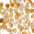 Macro shot of yellow acrylic irregular stone beads with pre-drilled holes for DIY jewelry - 50 Pieces / Amber
