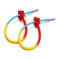 Close-up of rainbow gradient silicone ties with red star sliders for bags and DIY - Red