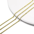 Close-up of 2mm yellow crystal rhinestone claw chains on white porcelain surface - 2.0mm (1m/Pack) / Silver Base Lemon Yellow