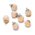 Close-up of glass globe pendants with yellow sequins and beads for DIY jewelry making - Orange