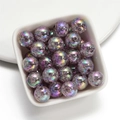 Macro shot of 16mm purple crackle acrylic beads with iridescent finish in a white bowl - Gray