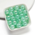 Macro view of mint green crackle acrylic beads with iridescent coating in a bowl - Lake Green