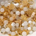 Macro view of gold metal charms and white crystal beads set for DIY jewelry making - White (Gold Accessories)