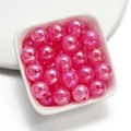 Macro shot of 16mm pink iridescent acrylic beads with ice crack patterns for DIY jewelry - Rose Red