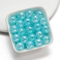 Macro view of 16mm blue crackle glass beads with iridescent AB coating in a bowl - Sky Blue