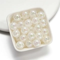 Macro shot of 16mm colorful acrylic crackle beads with AB coating in a white tray - White