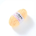Close-up of soft light yellow 4-ply milk cotton yarn with Hamanaka brand label - Light Yellow
