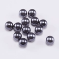 Macro shot of 13 dark grey smooth faux pearls for DIY jewelry making on white background - 6mm / Gray