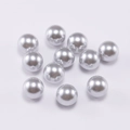 Macro shot of silver grey round seamless ABS faux pearls for DIY jewelry making - 6mm / Light Gray