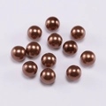Macro view of 12 glossy bronze ABS faux pearls for DIY jewelry making accessories - 6mm / Coffee