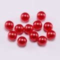 Close-up of vibrant red round ABS faux pearls for DIY jewelry making and crafts - 6mm / Red