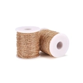 Close-up of fine golden metal curb chain wound on white spools for DIY jewelry making - 1.5mm (5m/21g) / KC Gold