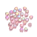 Macro view of pink heart acrylic beads with iridescent AB coating for DIY jewelry - Pink