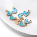 Macro shot of sky blue enamel heart pendants with gold beaded edges for DIY jewelry making - 10 Pieces/Pack (9x10mm) / Blue