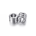 Close-up of cylindrical stainless steel spacer beads with triple parallel striped texture - 20 Pieces Set / Steel Color (5*4mm/ID 3mm)