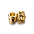 Detailed macro of golden cylindrical spacer beads with a grooved texture for DIY jewelry - 20 Pieces Set / Gold (5*4mm/ID 3mm)