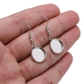 Close-up of silver-plated round tray ear hooks for DIY earring jewelry making held by hand - Round Style / 20mm (10 Pieces/Pack) / Silver