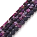 Macro detail of matte purple striped agate beads in various sizes for jewelry making - 4mm / Purple