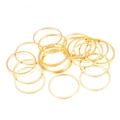 Close-up of polished golden brass closed jump rings for DIY jewelry making - 8mm / Gold