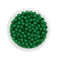 Top view of 6mm grass green acrylic spacer beads in a clear round plastic storage box - Dark Green