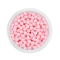 Macro shot of 6mm pink acrylic spacer beads in a clear box for DIY jewelry making - Light Pink