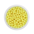 Close-up of 6mm light yellow acrylic round beads in a clear container for DIY jewelry - Light Yellow