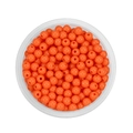 Close-up of 6mm orange round acrylic beads for DIY jewelry making in a plastic container - Orange