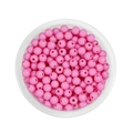 Close-up of pink 6mm acrylic round spacer beads for DIY jewelry making in a clear tray - Pink