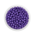 Macro shot of 6mm purple acrylic beads in a round tray for DIY jewelry making - Purple