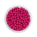Overhead macro of 6mm vibrant pink acrylic spacer beads for DIY jewelry making - Rose Red