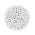 Detail of 6mm white acrylic spacer beads with holes in a round container for DIY crafts - White