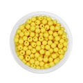 Top view of 6mm yellow acrylic spacer beads for DIY jewelry making in a round container - Yellow