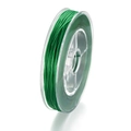 Macro view of transparent green crystal elastic beading thread on a clear plastic spool - Green