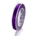 Detailed side view of purple silk-textured 3D printing filament on transparent spool - Purple 1