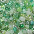 Macro detail of mixed green DIY craft beads in various textures and sizes for jewelry making - Green Series