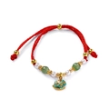 Detailaufnahme des roten geflochtenen Armbands mit Pferdeanhänger und Perlen - 1 Stück / Blaues Schaukelpferd mit grünen Glasperlen