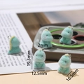 Macro view of mint green flocked dinosaur charm with dimensions 19.5mm by 12.5mm - Small Dinosaur