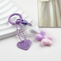 Detail of colorful resin heart charms and engraved metal tag on a sweet style keychain - White Purple Pink Heart