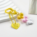 Detailed close-up of resin heart charms in yellow and pink on a stylish keychain - Yellow Pink White Heart