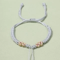 Detailed view of handmade peach blossom knot bracelet with adjustable silver-gray cord - Length approx. 12-25cm / Silver Gray